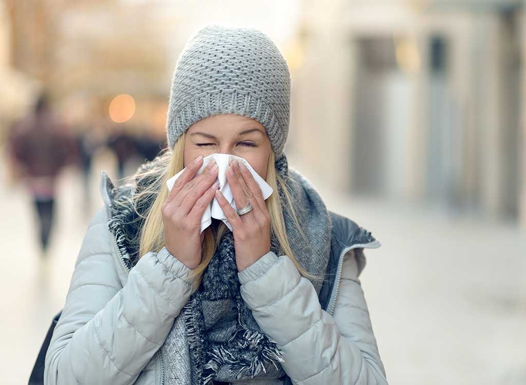 Woman with cold and sneezing