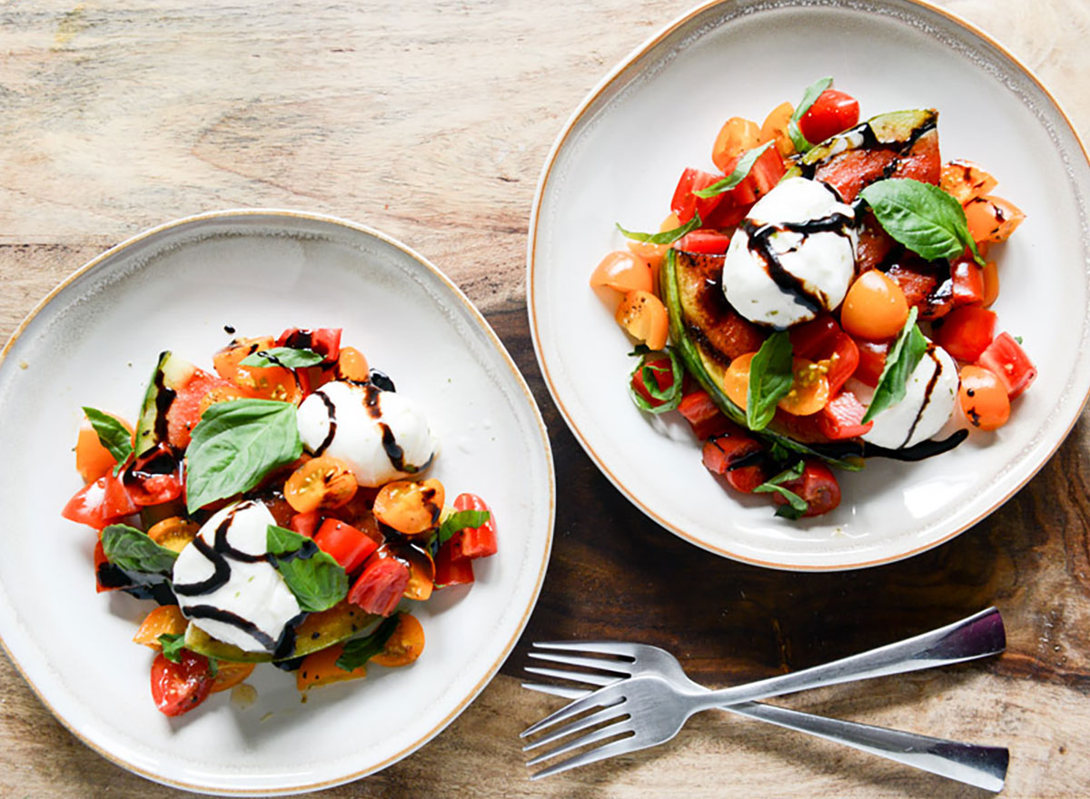 watermelon caprese salad in bowls with forks